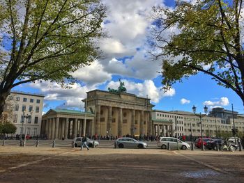 Statue in city against sky