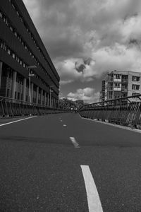 Surface level of road by buildings against sky