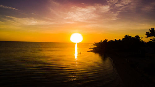 Scenic view of sea against romantic sky at sunset