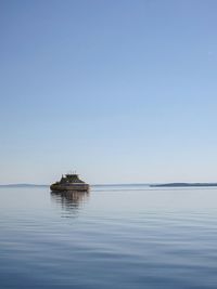 Scenic view of calm sea against clear sky