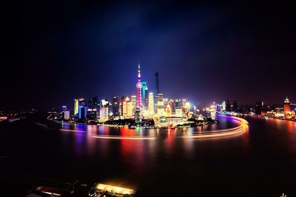 illuminated, city, architecture, night, building exterior, built structure, skyscraper, cityscape, tall - high, water, tower, capital cities, modern, waterfront, urban skyline, travel destinations, sky, river, travel, sea