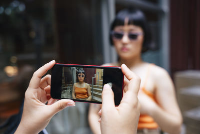 Midsection of woman using mobile phone