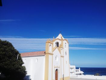 View of bell tower against blue sky