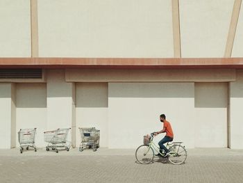 Man riding bicycle on street in city