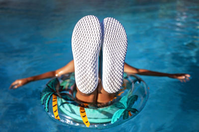 Low section of woman standing in water