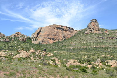 Rock formations on landscape against sky