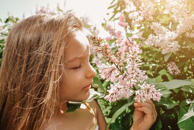 Close-up of cute girl smelling flowers
