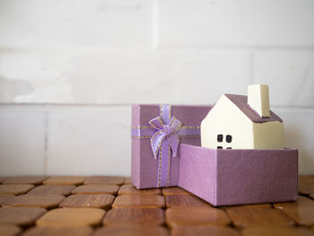 Close-up of model home in gift box on table