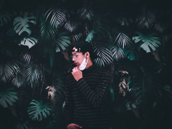 Portrait of young man holding plants