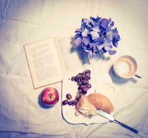 High angle view of breakfast and book on table