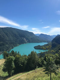 Scenic view of landscape and mountains against blue sky