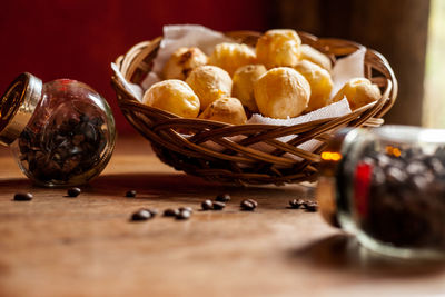 High angle view of roasted coffee beans with ingredients in jar on table