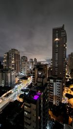 High angle view of illuminated buildings in city at night