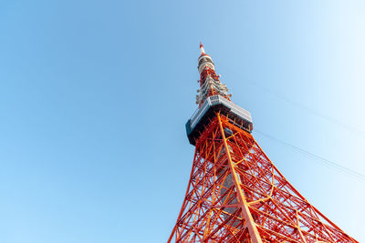 Low angle view of communications tower against clear blue sky