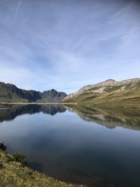 Scenic view of lake and mountains against sky