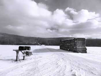 Built structure on snow covered landscape against sky