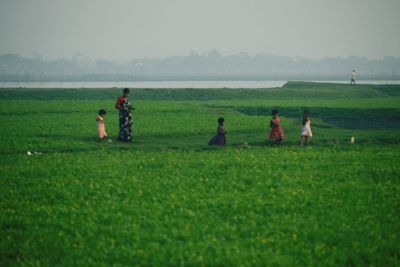 People on field against sky