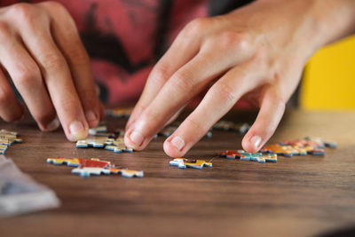 Midsection of man playing with toy on table