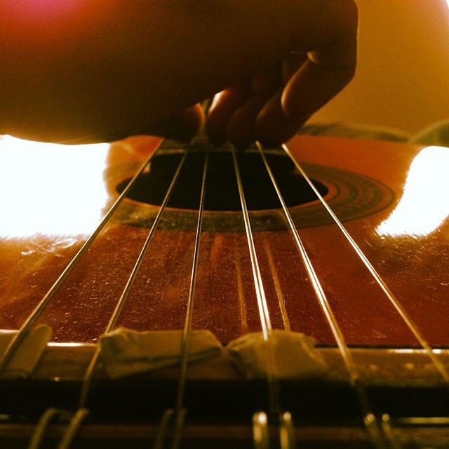 CLOSE-UP OF A GUITAR PLAYING