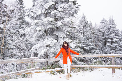 Woman standing on snow covered land