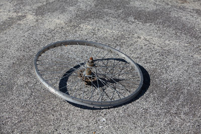 High angle view of abandoned bicycle wheel on street