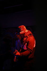 Side view of man with red umbrella
