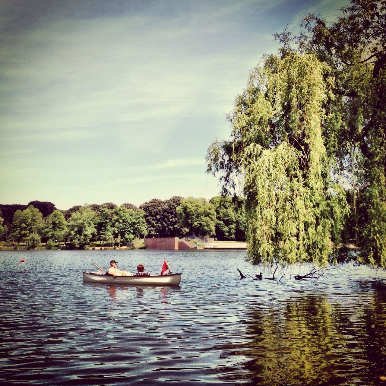 water, nautical vessel, tree, transportation, mode of transport, boat, men, waterfront, leisure activity, lifestyles, sky, lake, nature, person, tranquility, travel, beauty in nature, tranquil scene