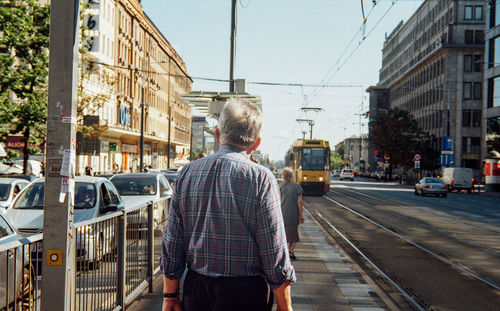 Rear view of man on city street