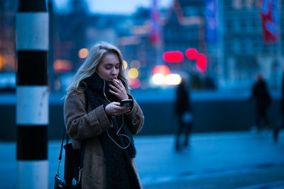 Young woman using mobile phone outdoors