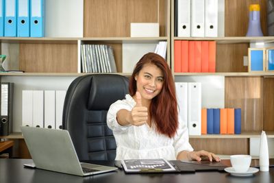 Portrait of smiling woman sitting at table