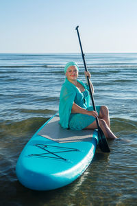 Man kayaking in sea