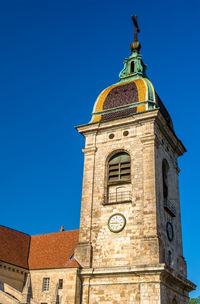 Low angle view of clock tower against sky