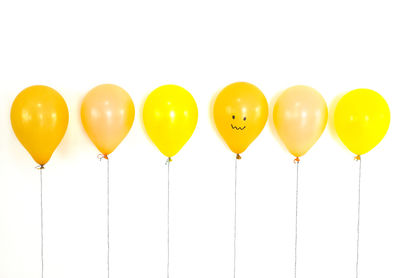Multi colored balloons against white background