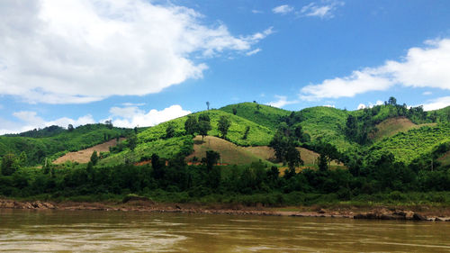 Scenic view of field and mountains against sky