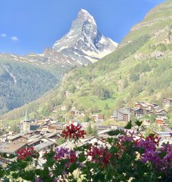 Scenic view of mountains and buildings against sky