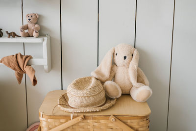 Stuffed toy a plush rabbit or rabbit and a straw hat in the decor of a children's room
