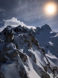 Scenic view of snow covered mountains against sky