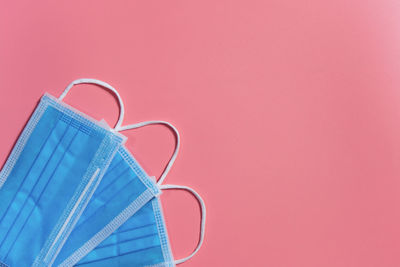 Close-up of sunglasses against pink background