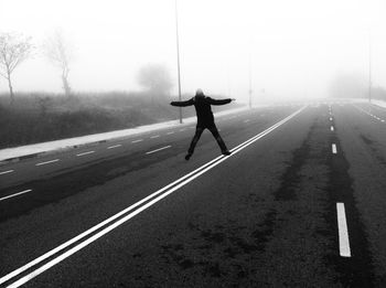 Rear view of man on road in city