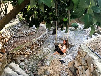 View of man sitting on rocks