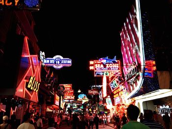 Illuminated city street at night