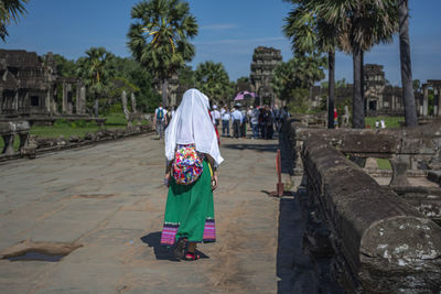 Rear view of women walking in temple