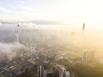 Aerial drone view of misty low clouds sunrise over kuala lumpur