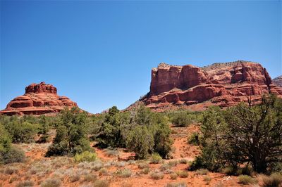 Low angle view of rock formation against clear blue sky