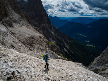 High angle view of female hiker walking on mountain