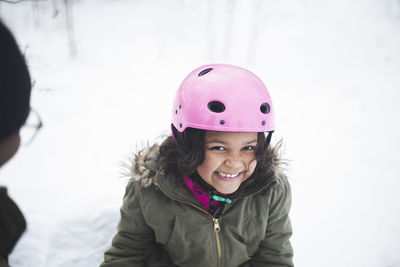 Portrait of a smiling girl in snow