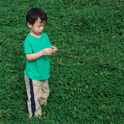 Little girl standing on grassy field