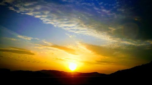 Scenic view of silhouette mountains against sky during sunset