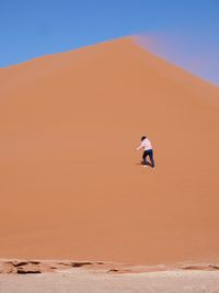 Full length of man in desert against sky