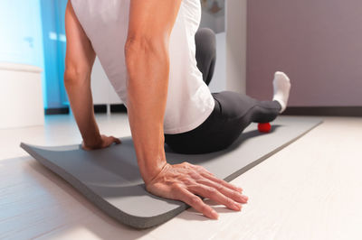 Low section of woman exercising at home